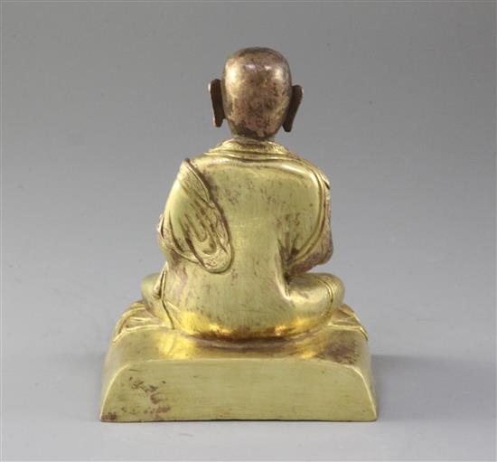 A Chinese gilt copper seated figure of a luohan, probably Qing dynasty, height 15cm